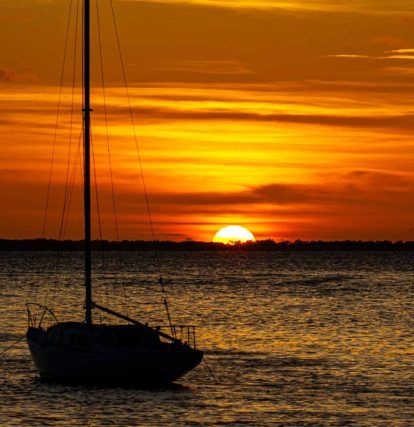 boat floating on the water during sunset